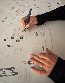 individual sketching logo ideas on paper